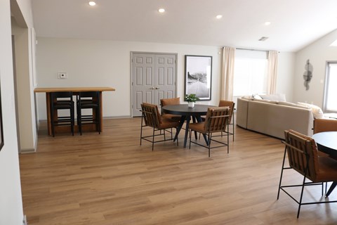 A living room with a dining table and chairs.
