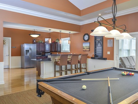 A pool table with a ball and cue stick on it.