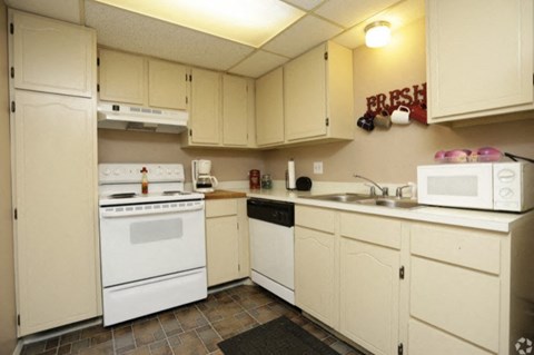a kitchen with white appliances and white cabinets