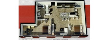 A model of a house with a kitchen, living room, and bathroom.