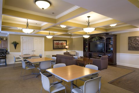 A living room with a dining table and chairs.
