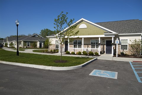 A parking lot with a handicap parking space in front of a building.