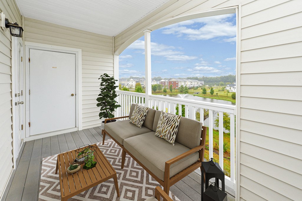 a living room with a couch and a table on a balcony