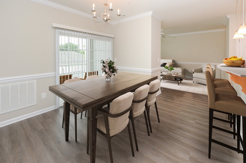 a dining room and living room with a table and chairs