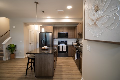 A kitchen with a black countertop and wooden cabinets.