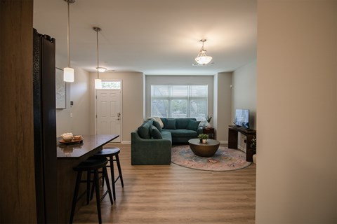 A living room with a couch, a table, and a television.