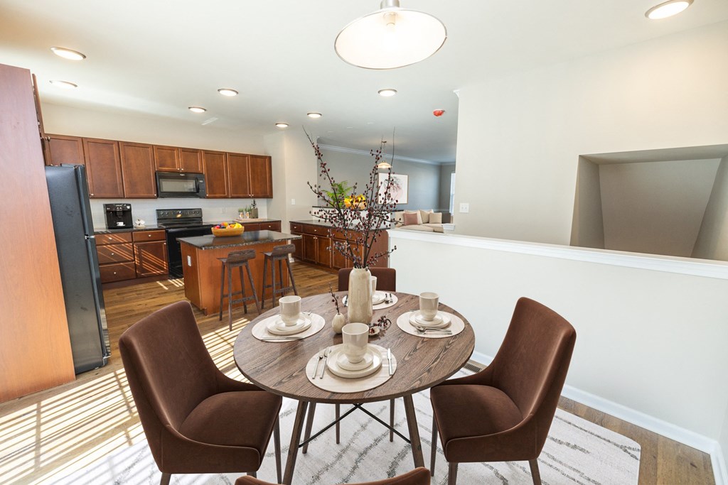 a dining room and kitchen with a table and chairs
