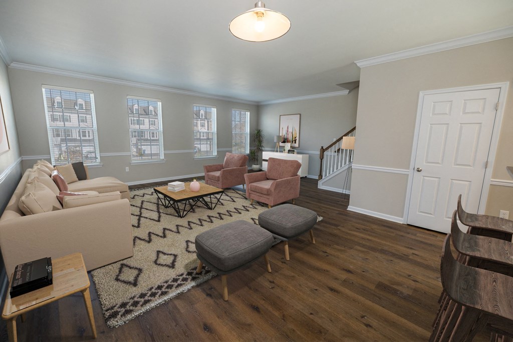 a living room with couches and chairs and a rug