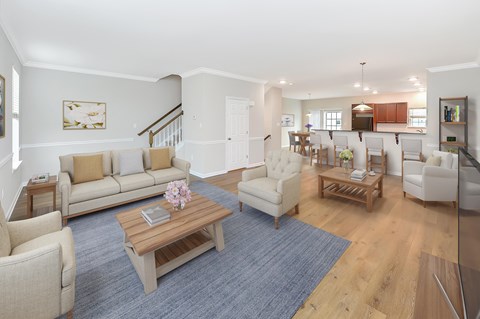 a living room with couches and chairs and a table