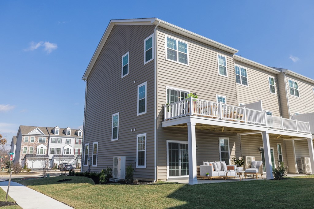 a house with a porch and a deck on a sunny day