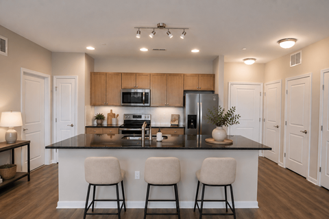 A kitchen with a black countertop and white walls.