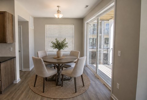 A dining room with a round table and chairs.