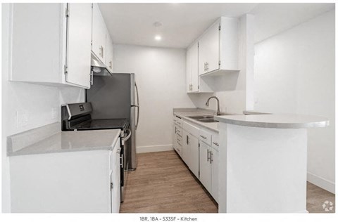 a kitchen with white cabinets and a stove and a refrigerator