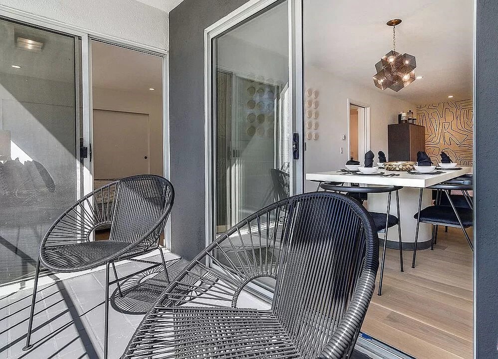 a patio with two chairs and a table