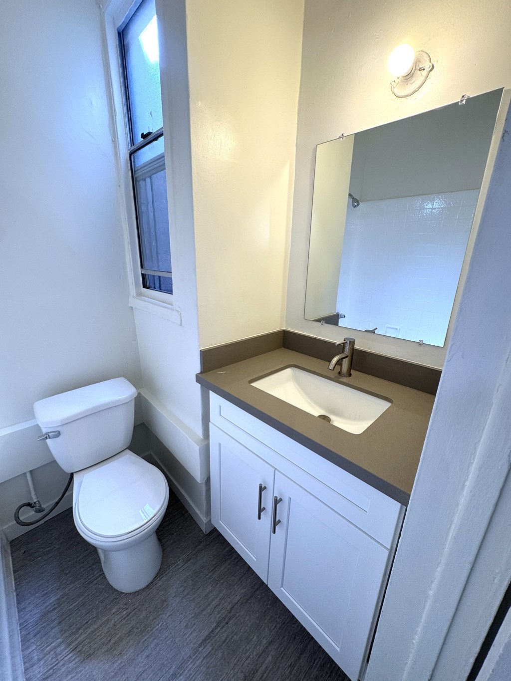 A white toilet sits next to a sink in a bathroom.