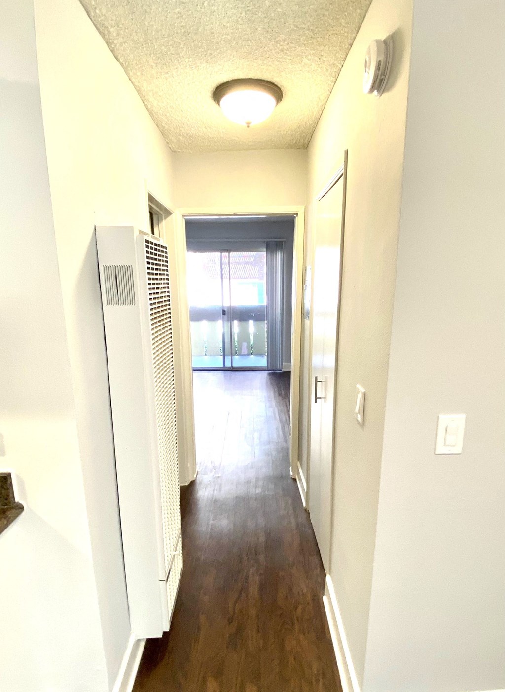 Hallway featuring closet space and heater vent  at Parc Meridien, Los Angeles, California