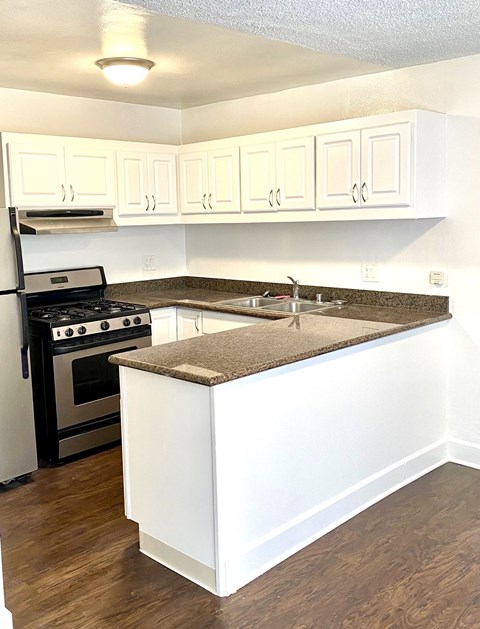 a kitchen with white cabinets and a counter top