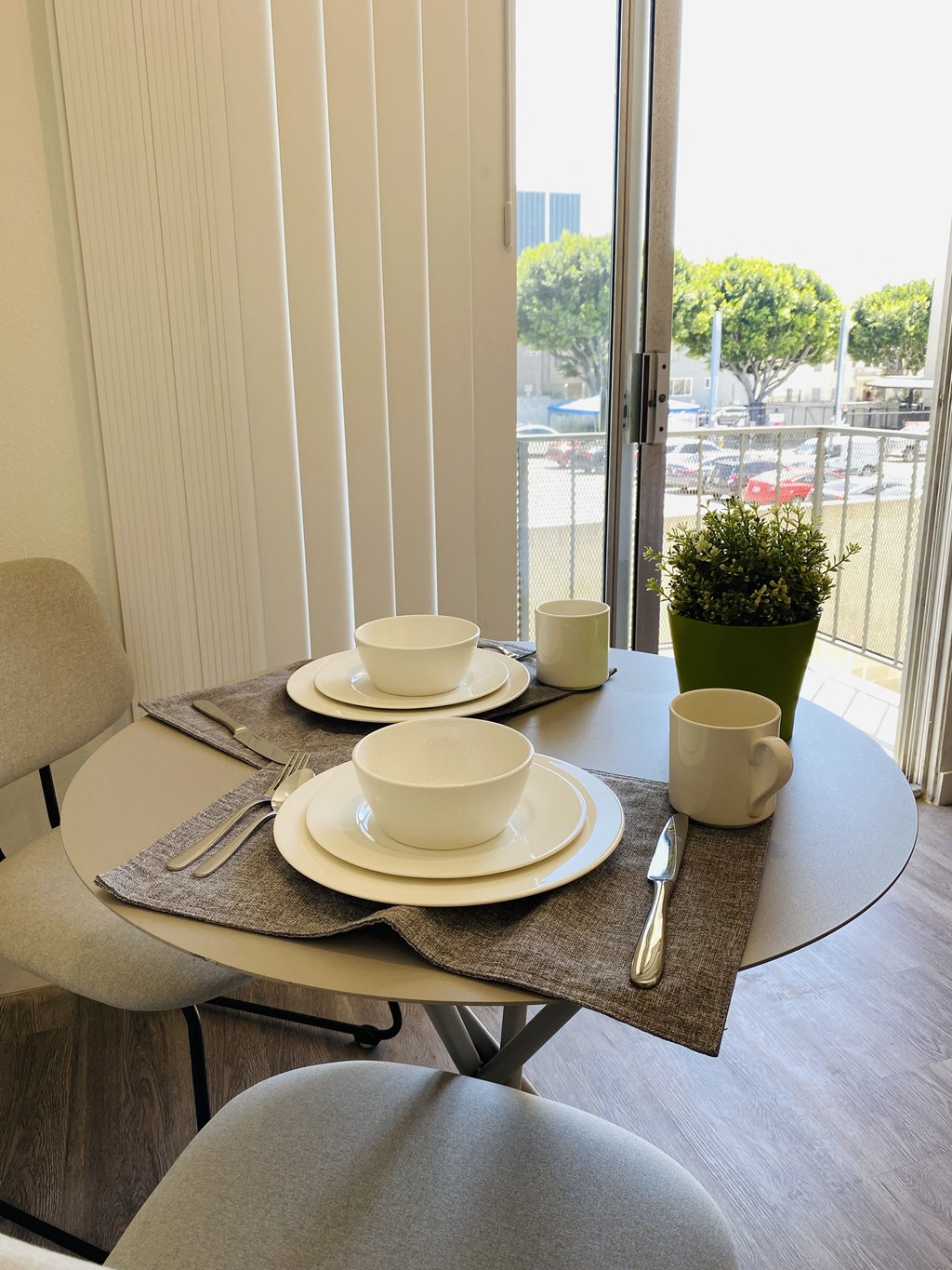 a dining room with a table and chairs and a balcony