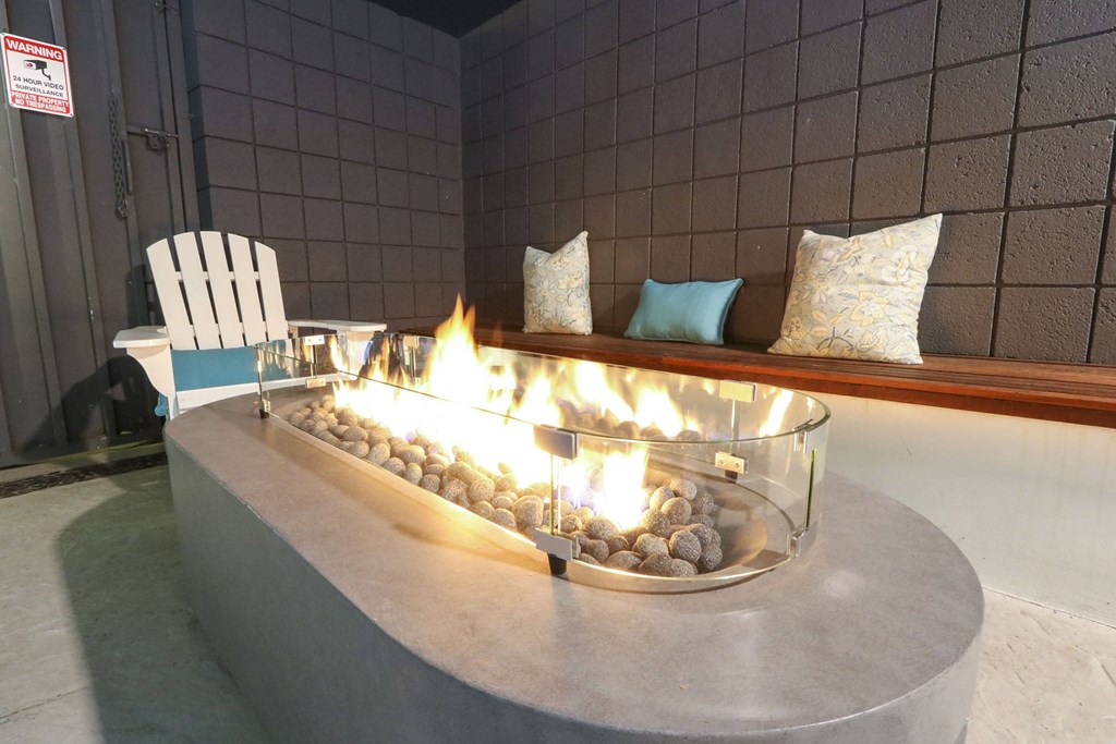Pool side fire pit table at Westwood Riviera Apartments, California