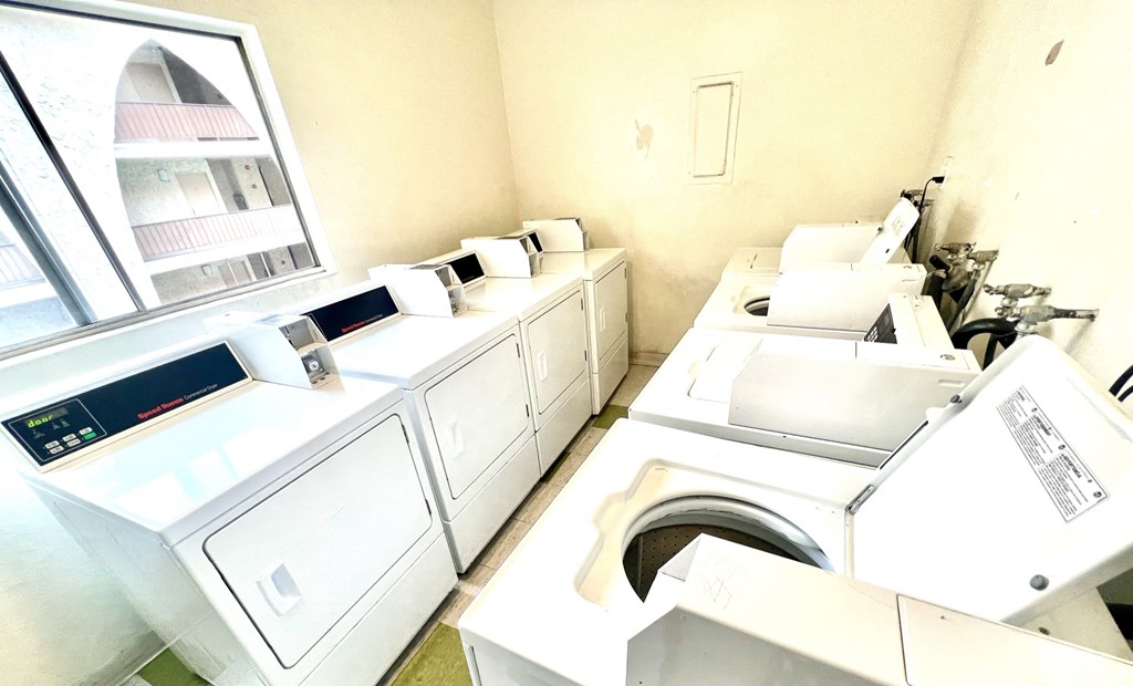 Laundry facility featuring four washing machines and four dryers 