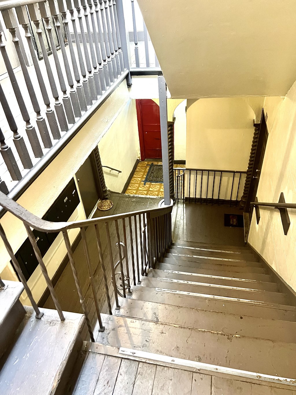 Stair case from second floor featuring mail box  area on the first floor