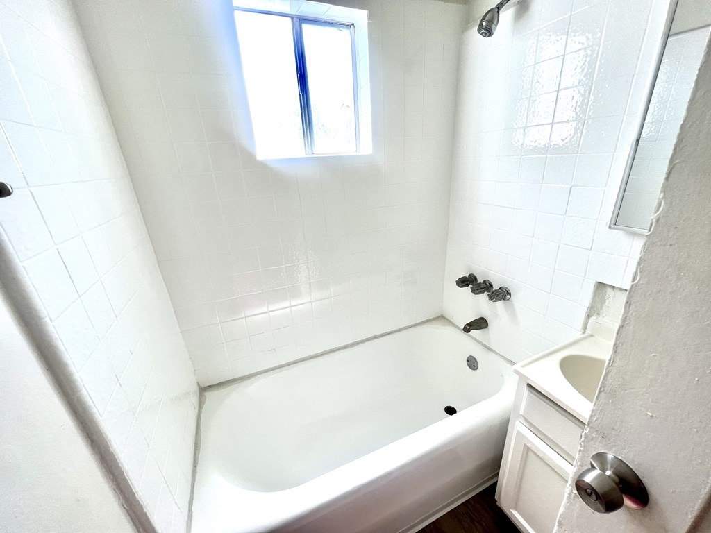 White shower enclosure full bath with vanity