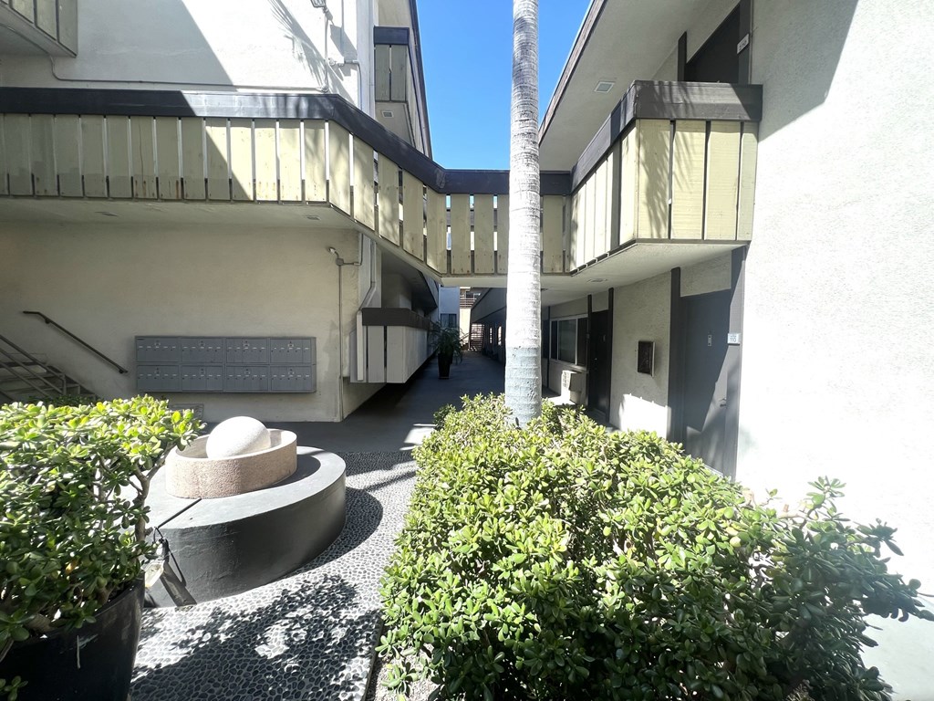 Courtyard view of mailbox, landscape, water feature, and walkways at Parc Meridien, California, 90020