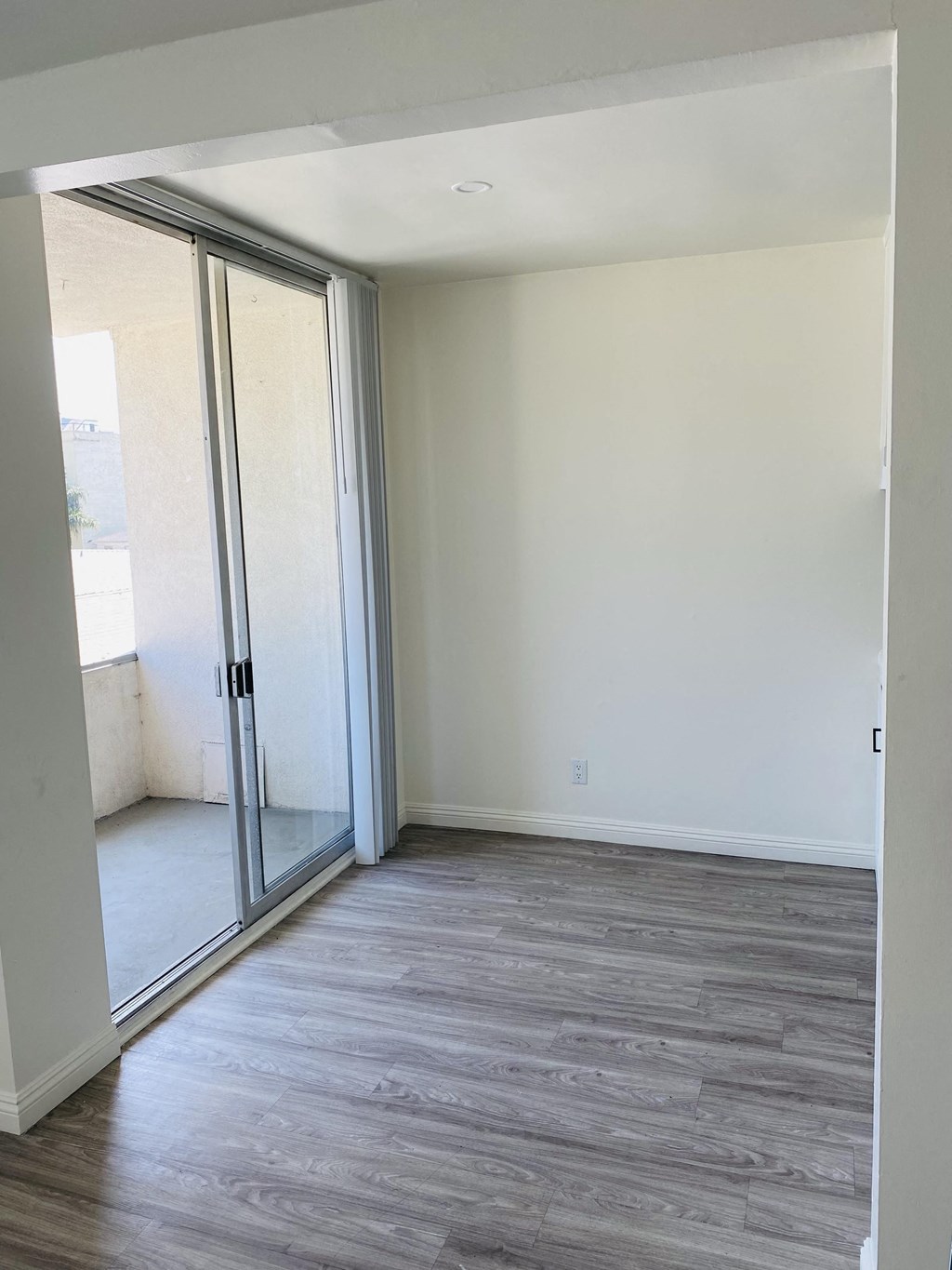 an empty living room with a sliding glass door