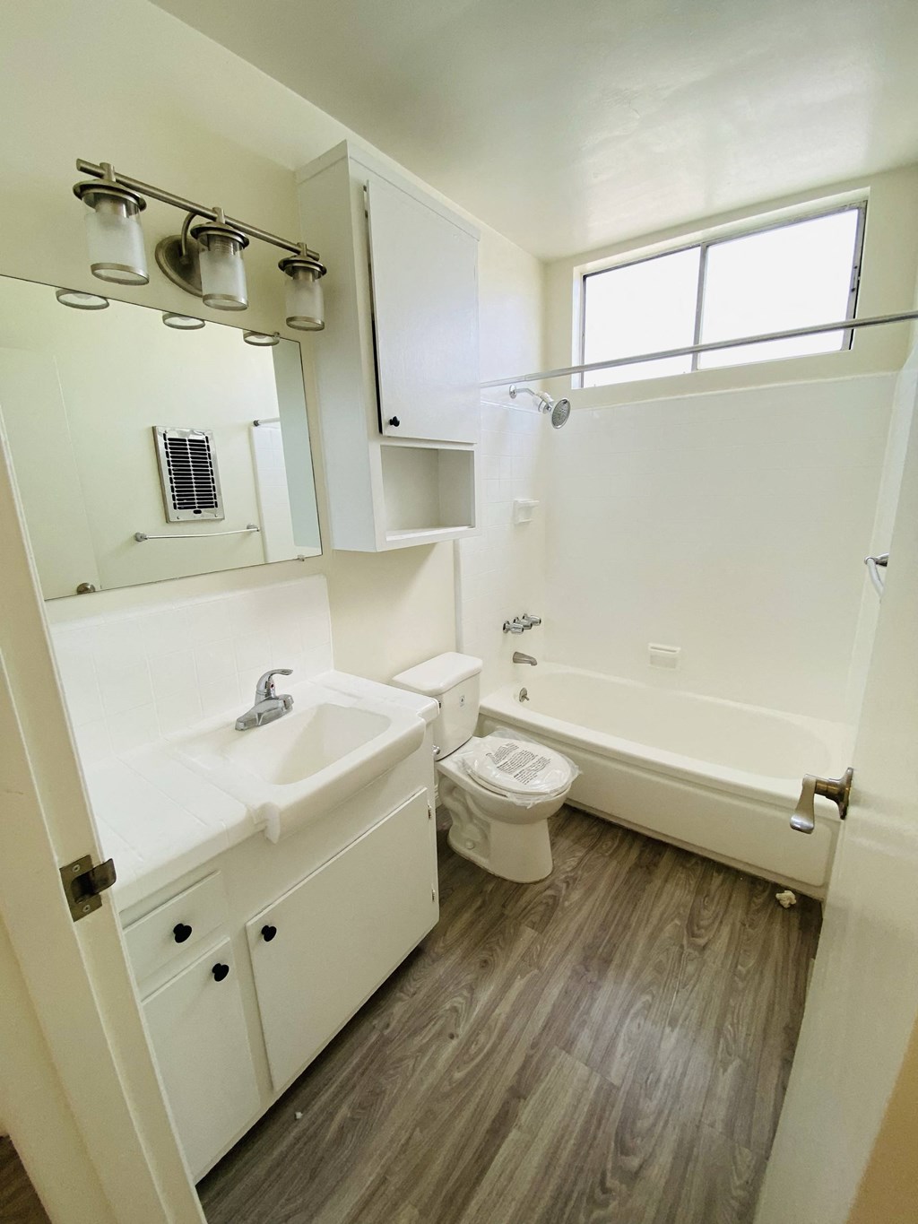 an empty bathroom with a sink toilet and bath tub