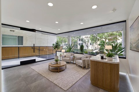 A modern living room with a wooden coffee table and a large window.