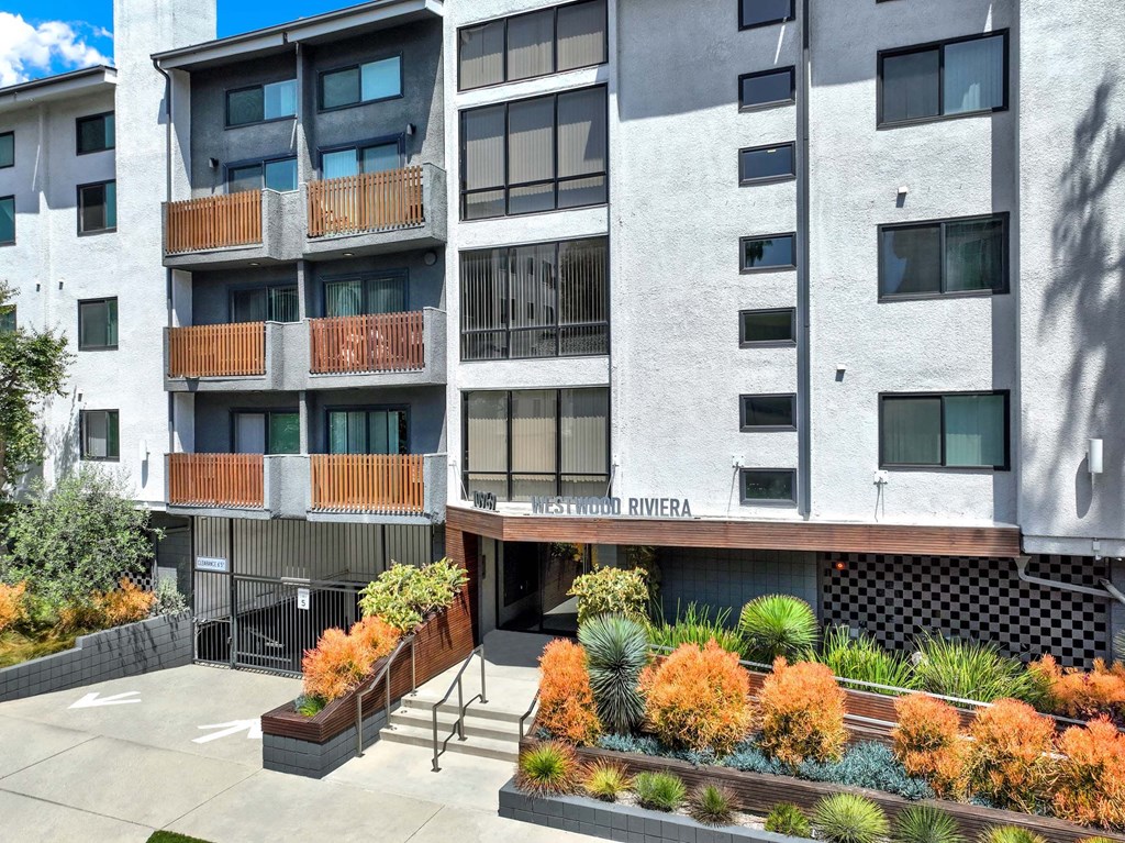 A modern building with a balcony and a sign that says "Rivera".