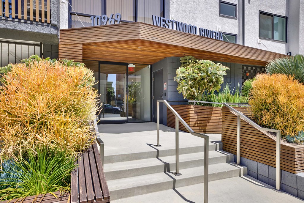 A building with a wooden entrance and steps leading up to it.