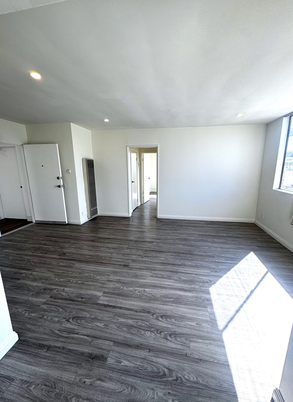 A room with a wooden floor and white walls.