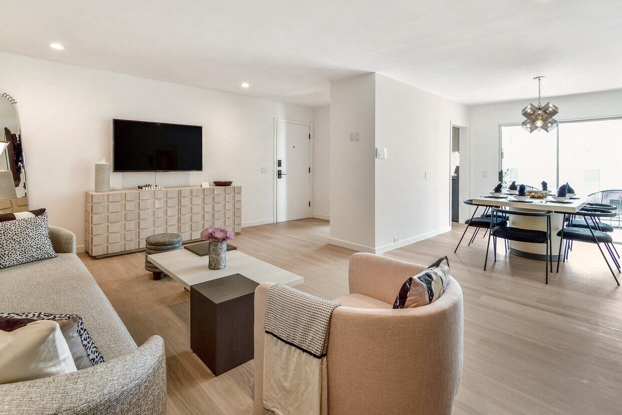 a living room and dining room with a table and chairs