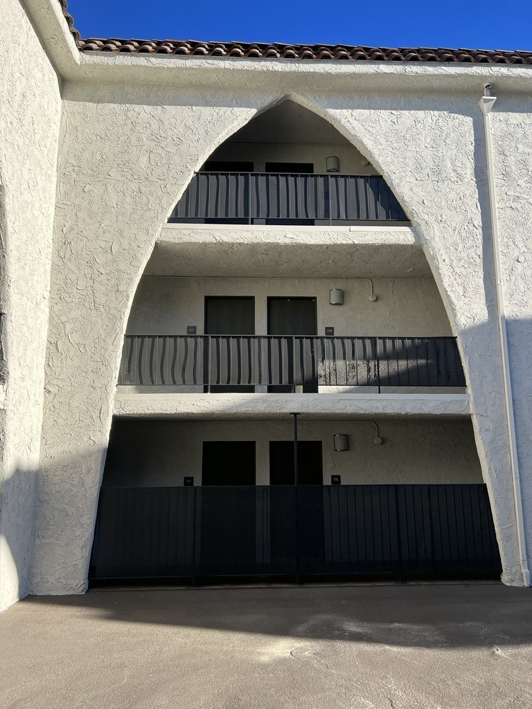 a building with a balcony and a black gate