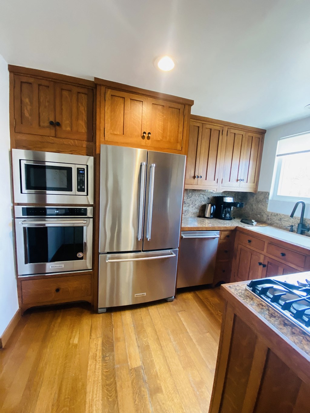a kitchen with stainless steel appliances and wooden cabinets