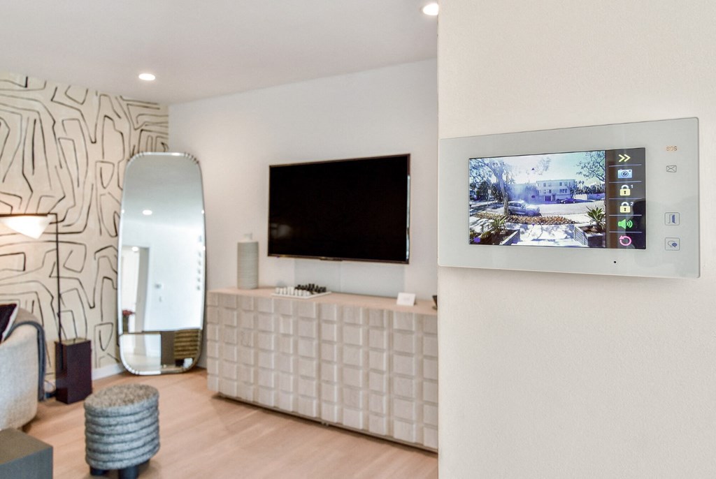 a living room with a television on the wall