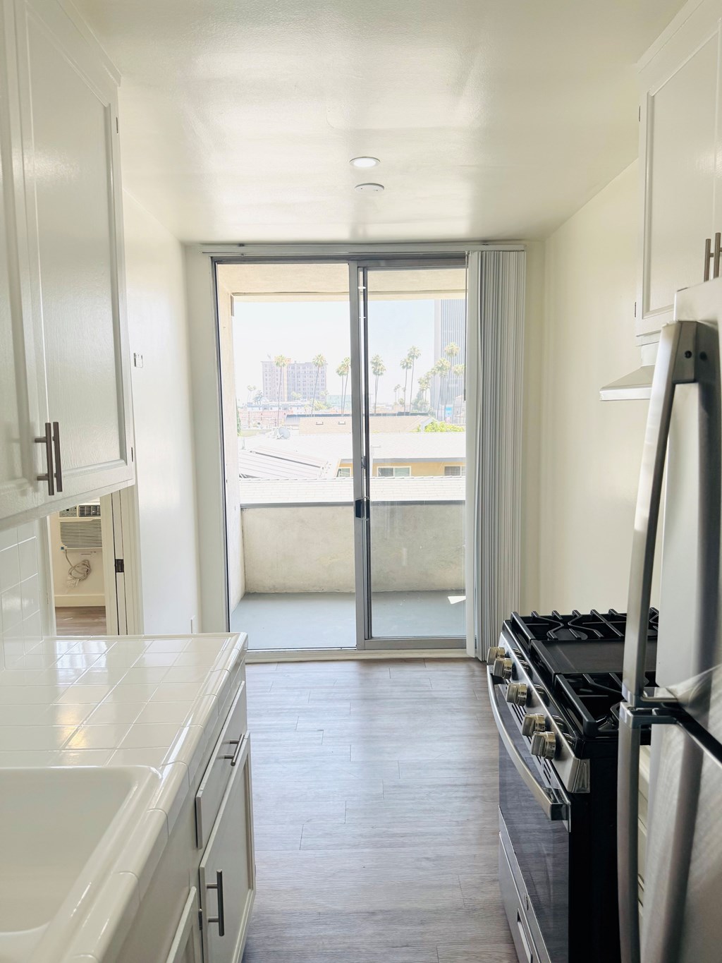 A kitchen with a stove and a sink.