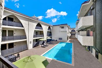 A sunny day at the pool in a modern apartment complex.