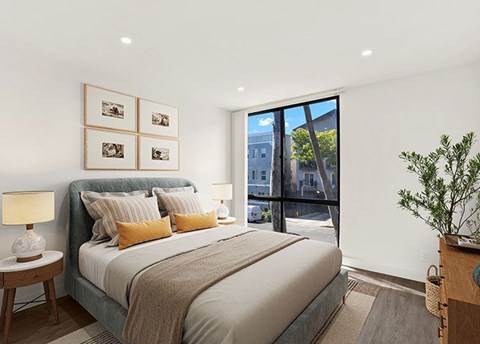 A bedroom with a large bed and a view of the city.