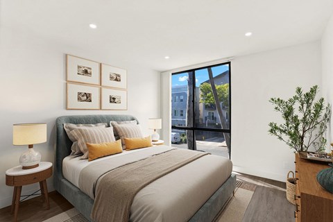 A bedroom with a large bed and a view of the outside.