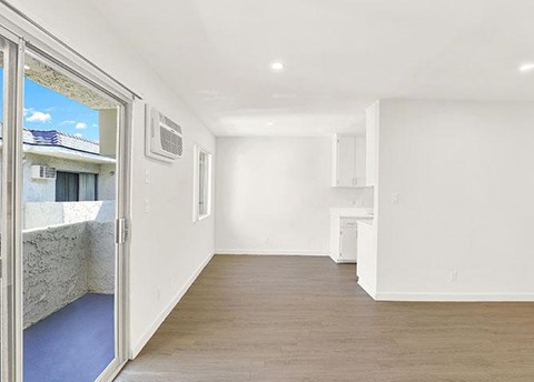 A room with a window and a door leading outside.