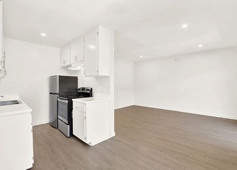 A kitchen with white appliances and cabinets.