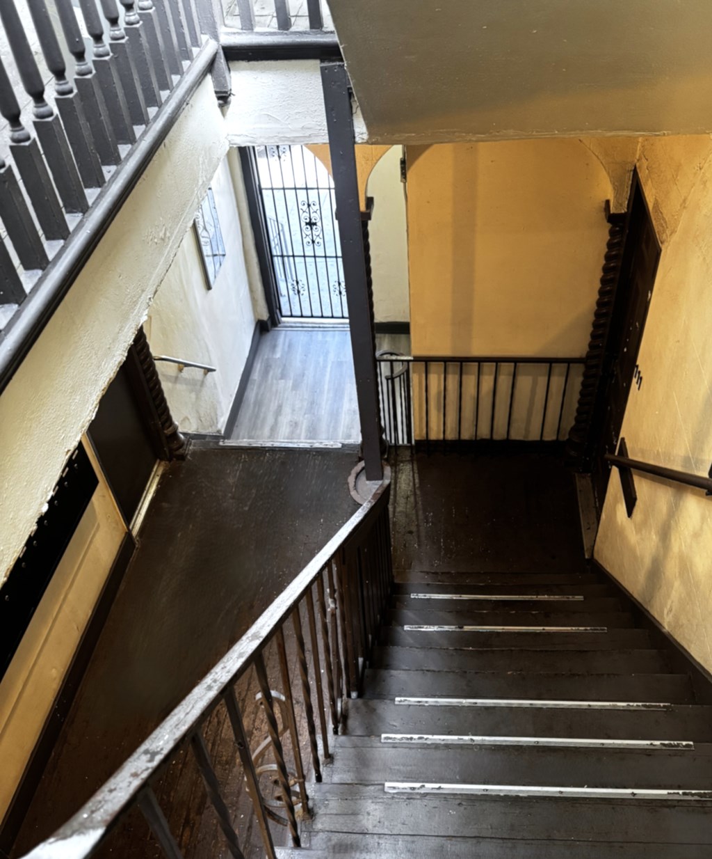 A staircase with a metal railing and wooden steps.