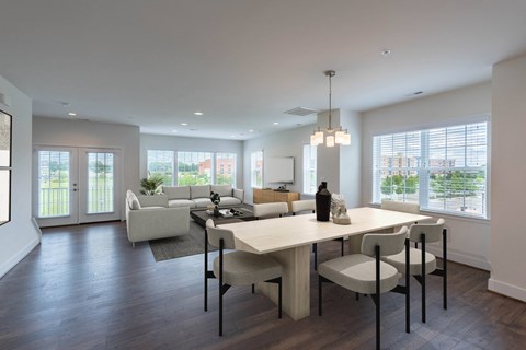 A modern dining room with a table set for four.