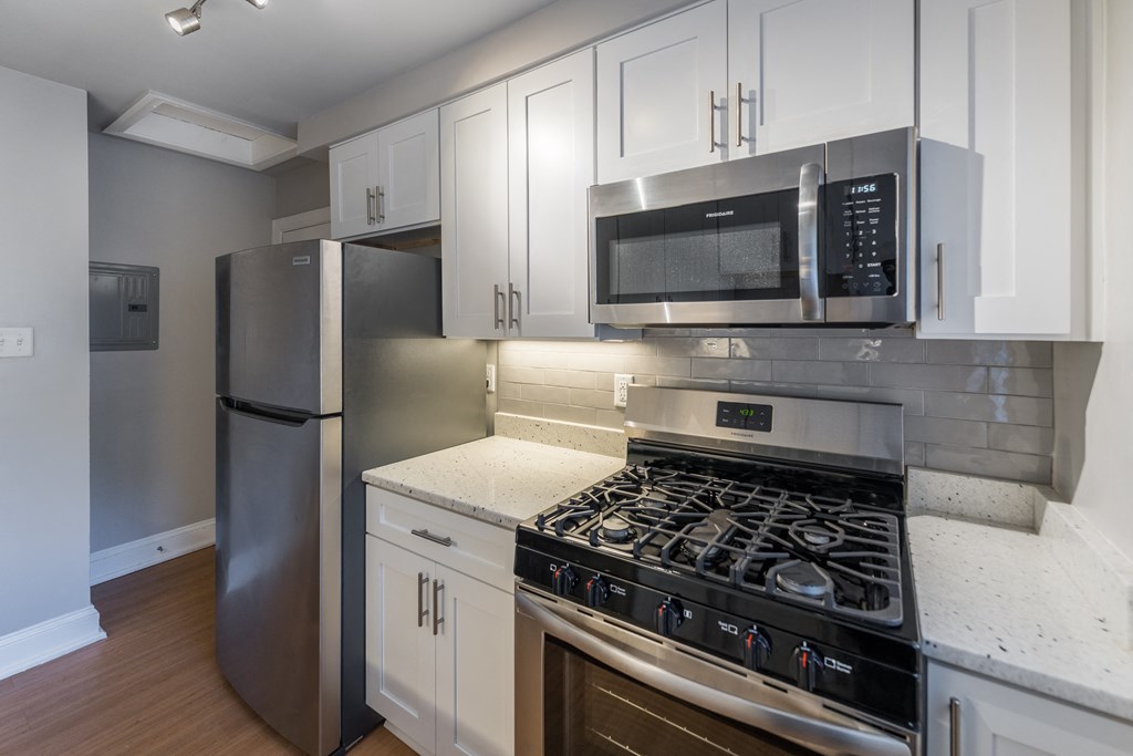 The Cary renovated kitchen with white cabinets, stainless steel appliances and a microwave The Cary renovated kitchen with white cabinets, stainless steel appliances and a microwave