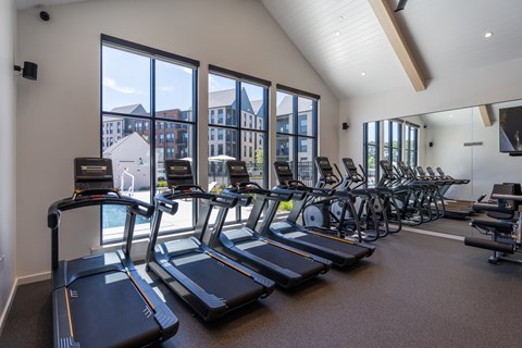 A gym with treadmills and exercise bikes.