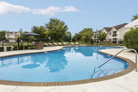A large swimming pool with a ladder on the side.