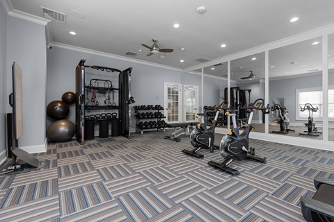 A spacious home gym with a variety of exercise equipment.