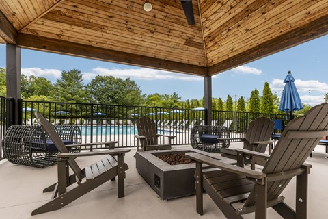 A wooden deck with chairs and a table.